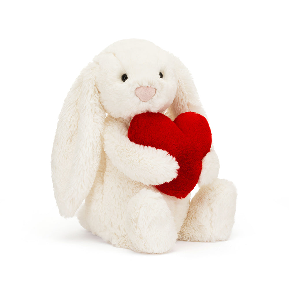 jellycat white bunny soft toy sitting holding a red heart