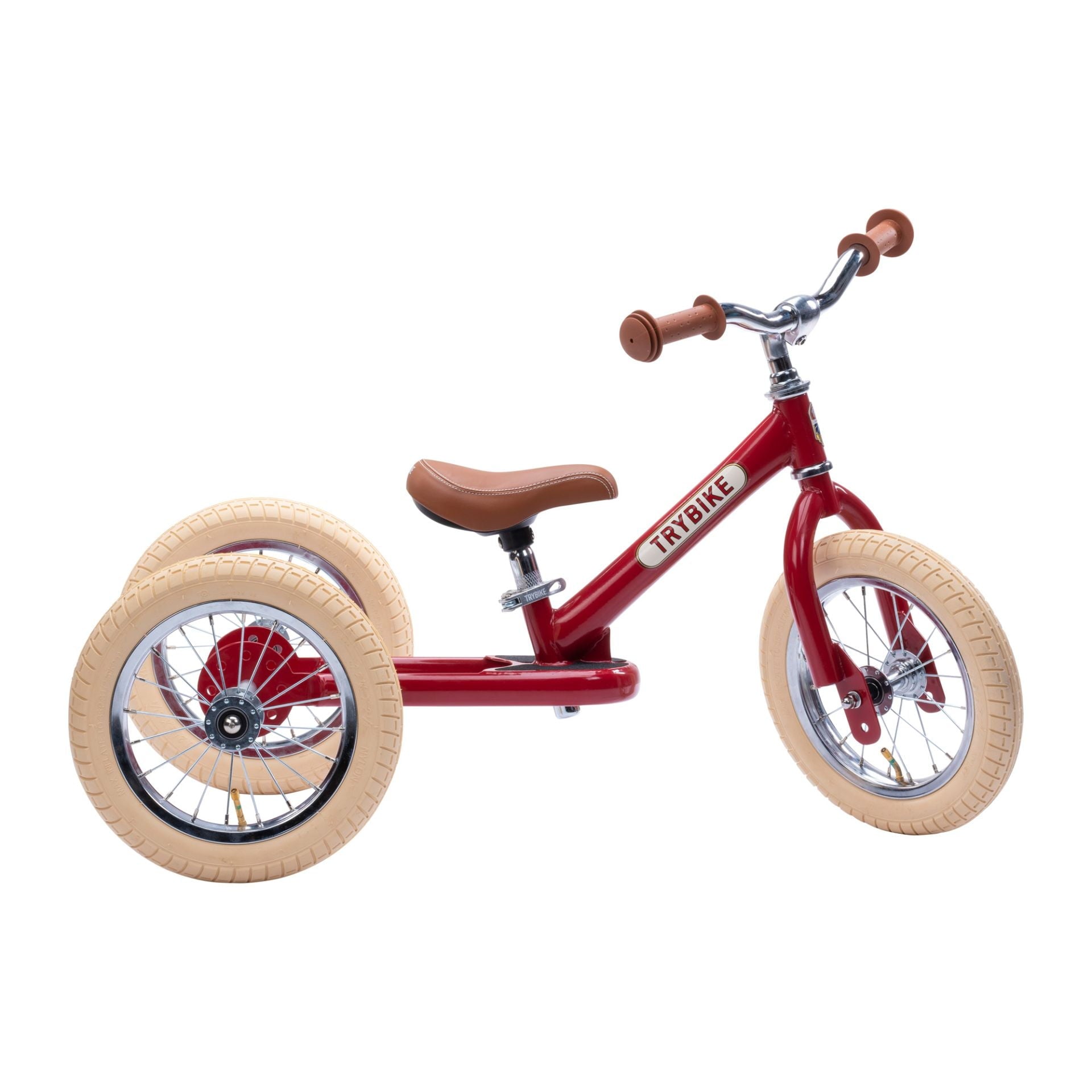 trybike tricycle with a red frame brown seat and handles and cream wheels