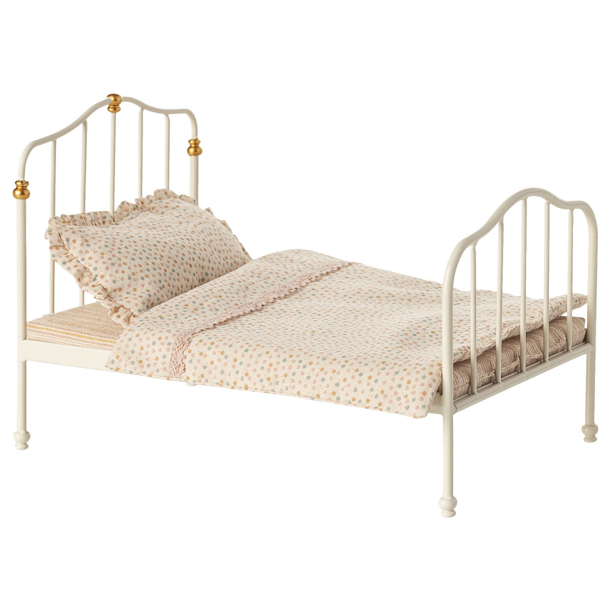 Small dollshouse bed for maileg mice with beige bedding and gold accents on a white background