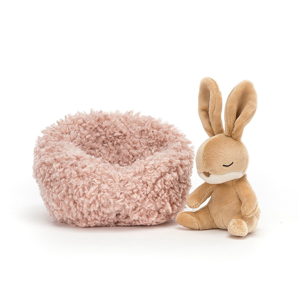 little jellycat bunny sitting next to his blush pink cushion bed
