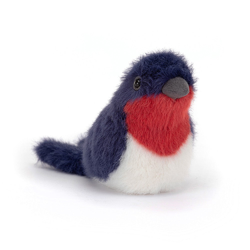 little soft toy bird by jellycat with deep blue fur and a red and white chest by jellycat