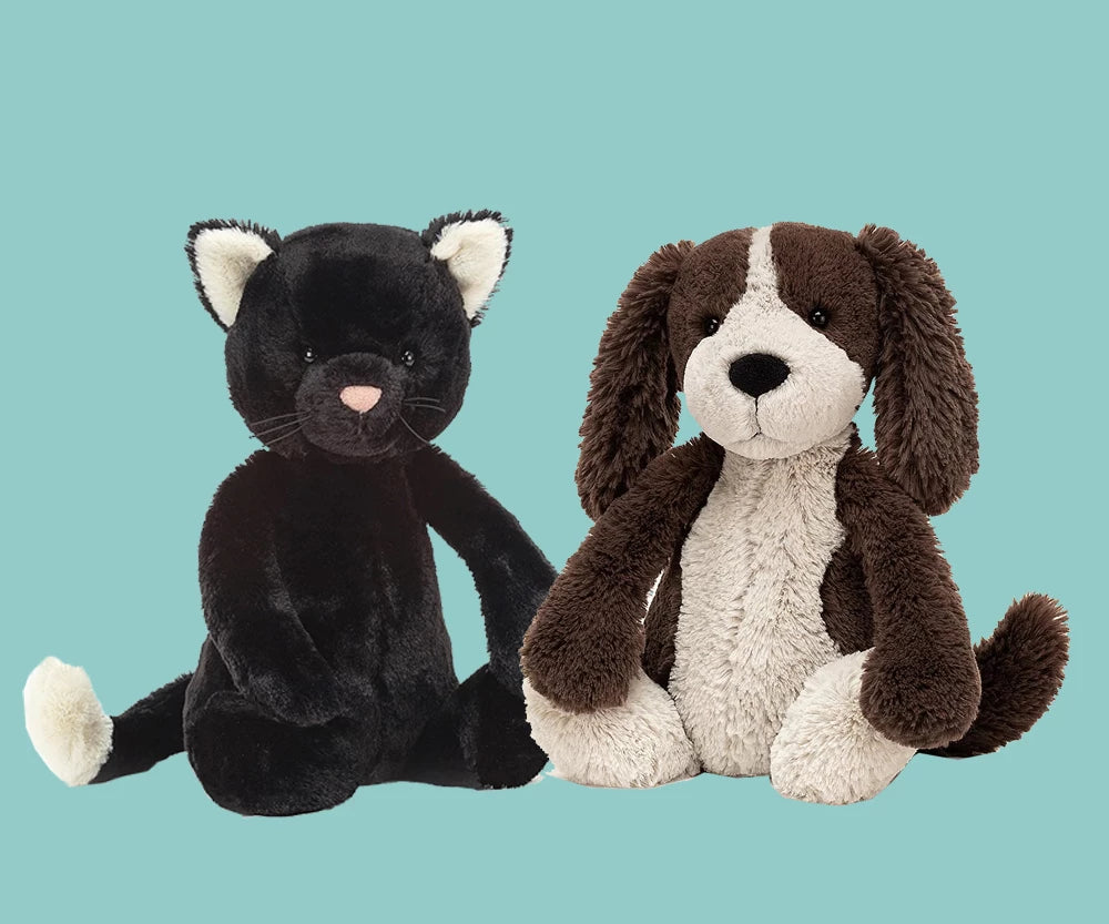 jellycat black cat sitting with white ears and a brown and cream dog 