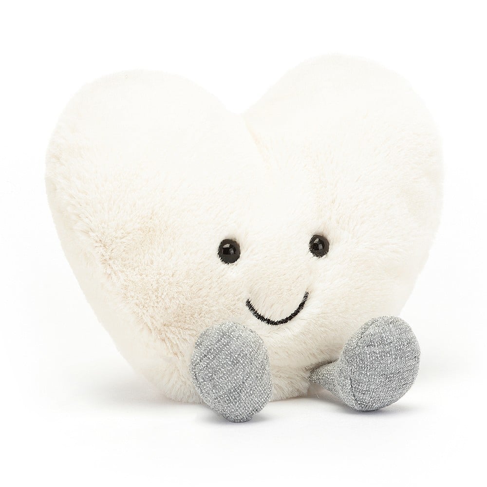 jellycat cream heart sitting, it has black beads eyes and a smiley embroidered mouth 
