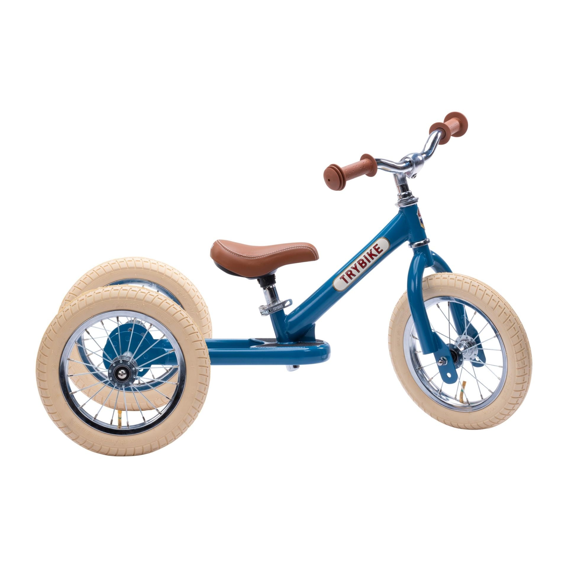 trybike tricycle with a blue frame brown seat and handles and cream wheels